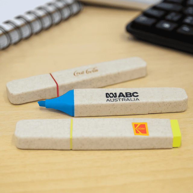 A set of eco-friendly highlighters in blue, yellow, and greyish beige, with various branding elements.