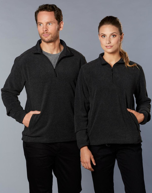 A grey half zip polar fleece pullover on two models, one male and one female, both with pockets and standing side by side.