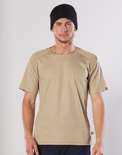A beige short-sleeve work t-shirt with a textured shoulder design, worn by a model in a black beanie.
