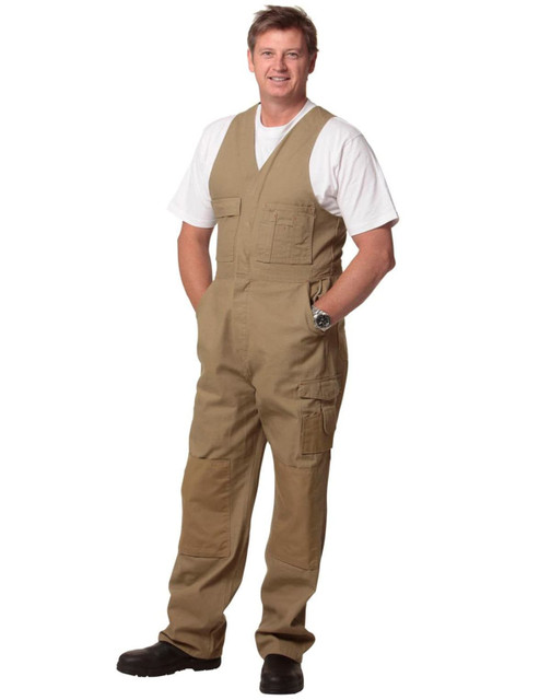 Men's DURA WEAR action back overalls in khaki, featuring multiple pockets and a logo, worn by a man.