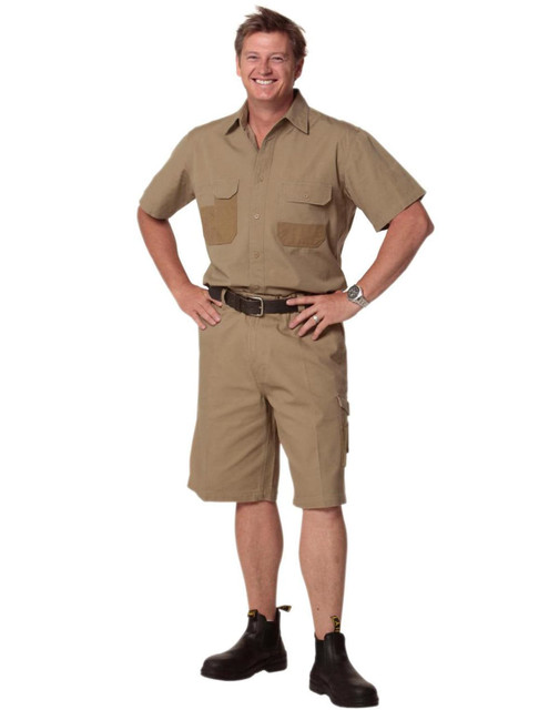 A short-sleeve, khaki work shirt with two chest pockets, paired with matching shorts, worn by a smiling man.