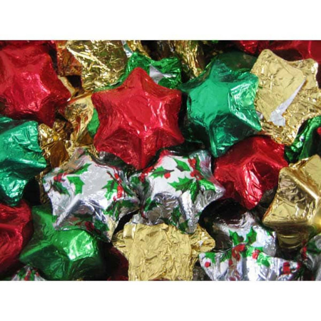 Chocolate stars wrapped in red, green, gold, and silver foil, forming a colourful festive display.