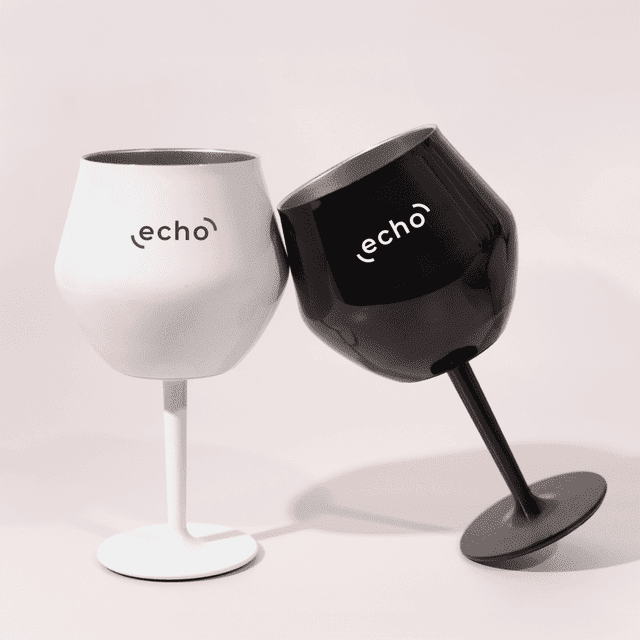 Two detachable wine glasses in black and white, featuring a logo on each, positioned together.