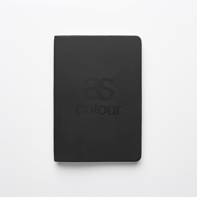 A black notebook featuring a logo on the front cover, with a smooth, matte finish.