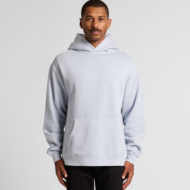 A light blue hoodie with a front pocket and a large hood worn by a model. The hoodie features a logo.