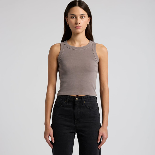 A fitted ribbed crop tank in faded grey, paired with high-waisted black jeans. The garment features minimal branding.