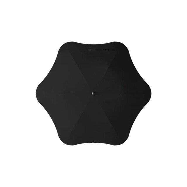 A black BLUNT Metro Umbrella with a unique shape and central button. It features a minimalist design.