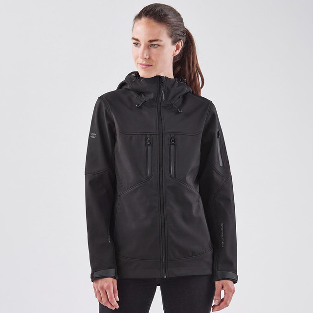 A black softshell jacket with a hood, featuring multiple zippered pockets and a logo.