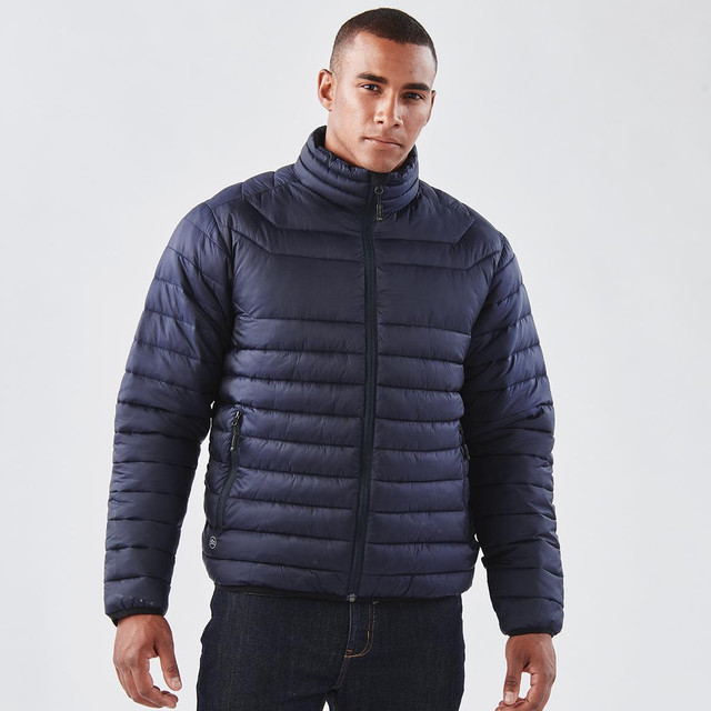 A navy puffer jacket features a high collar and zippered front, worn by a model against a plain background.