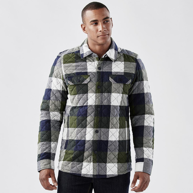 A men's shacket in a quilted, navy, green, and grey plaid pattern with front pockets and a collar.