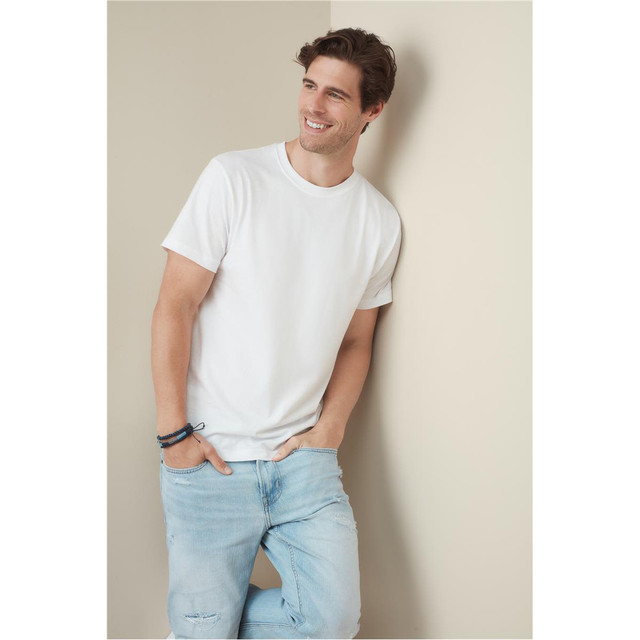 A men's classic white T-shirt, featuring a round neck and short sleeves, paired with light blue jeans.