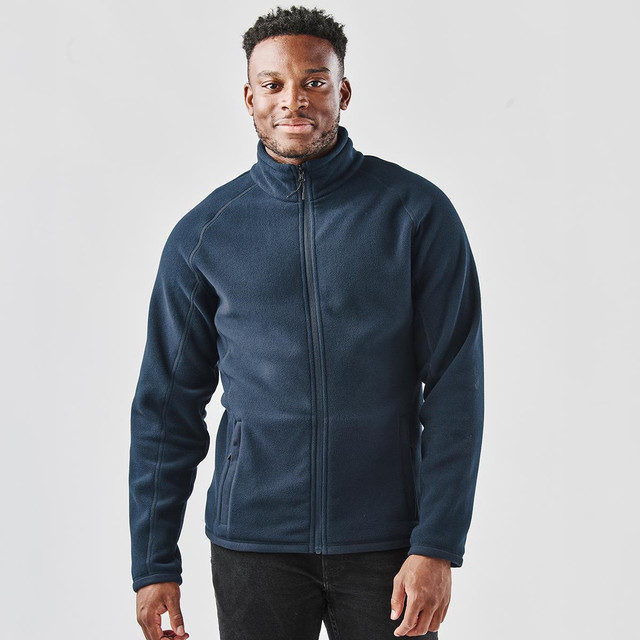A navy fleece jacket with a zip front and stand collar, featuring a logo and two side pockets.