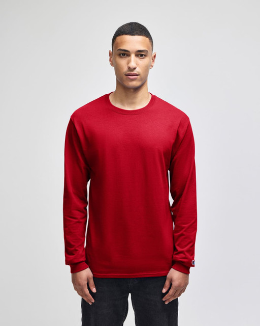 A red long-sleeve t-shirt featuring a logo on the sleeve, presented on a model against a plain background.