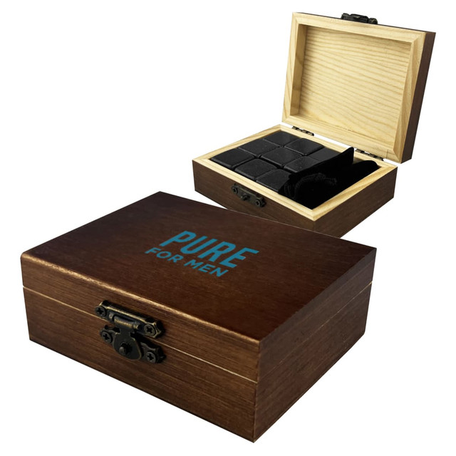 A wooden box containing black stone whiskey ice cubes, with a hinged lid and a logo on the exterior.