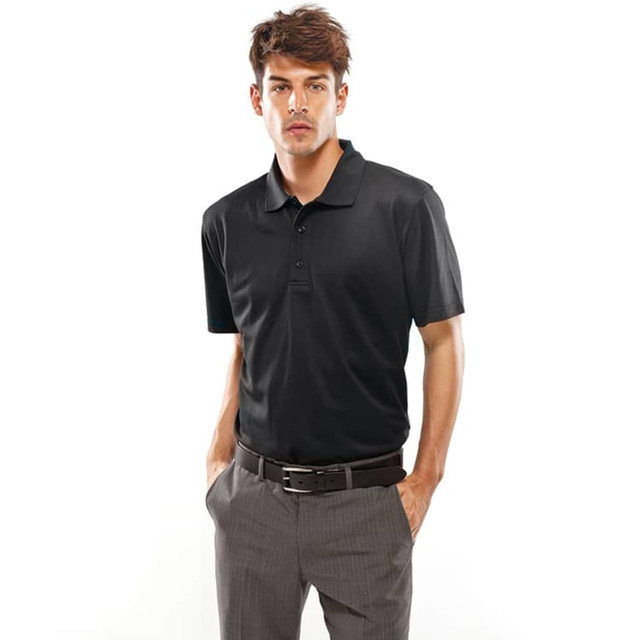 A black polo shirt worn by a model, featuring a collar and short sleeves. The model is paired with grey trousers.