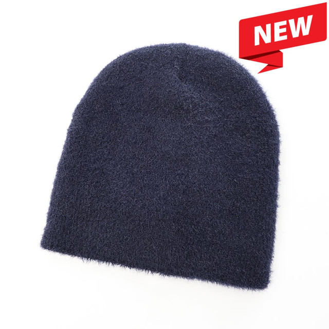A dark navy beanie made from a soft, shaggy material, featuring a logo on the side.