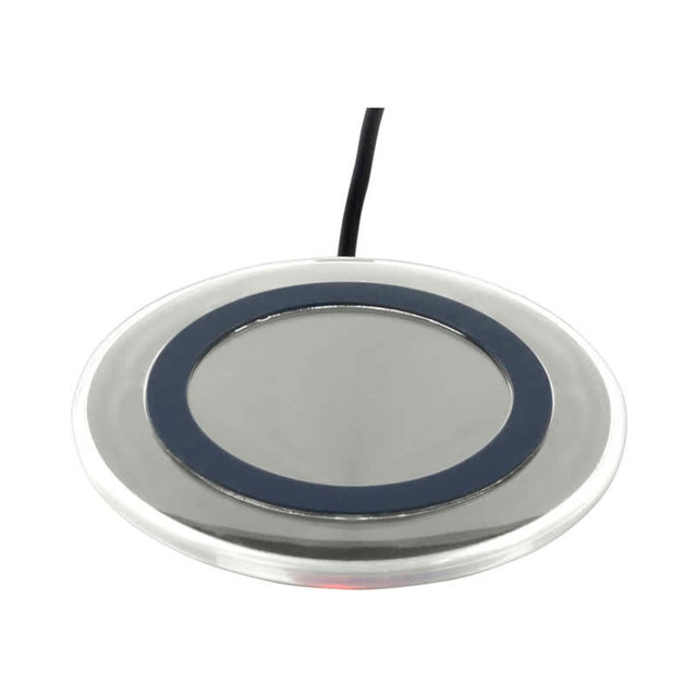A round silver wireless charger with a black ring around the centre and a connected cable.