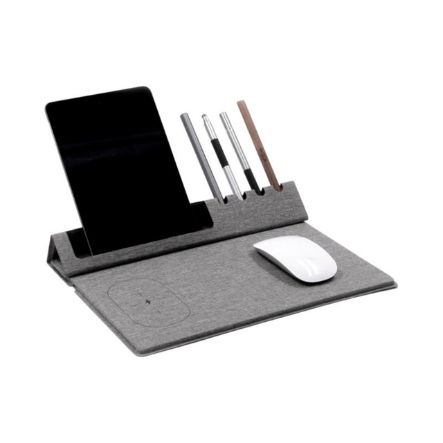 A grey mouse pad with a built-in phone holder, pen slots, and a wireless charging area for devices.