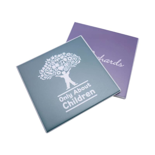 A teal and purple welded coaster featuring a tree graphic and a logo. The coaster is square-shaped.