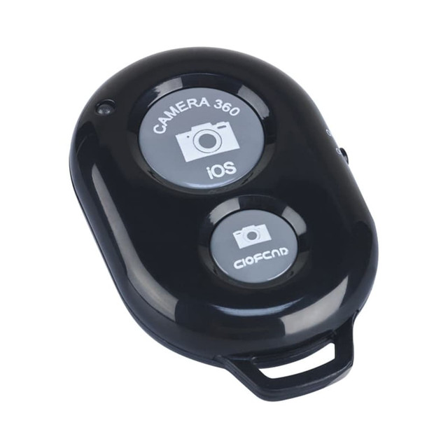 A black selfie button remote featuring two buttons for camera activation, with a logo on the surface.
