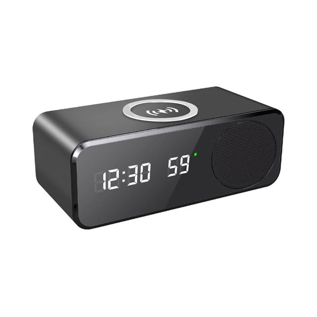 A black wireless charging speaker featuring a digital clock display and a speaker grille. It has a logo on the front.