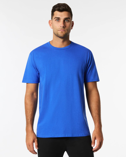 A blue Gildan Ultra Cotton adult t-shirt on a model, featuring a plain design and a logo on the label.