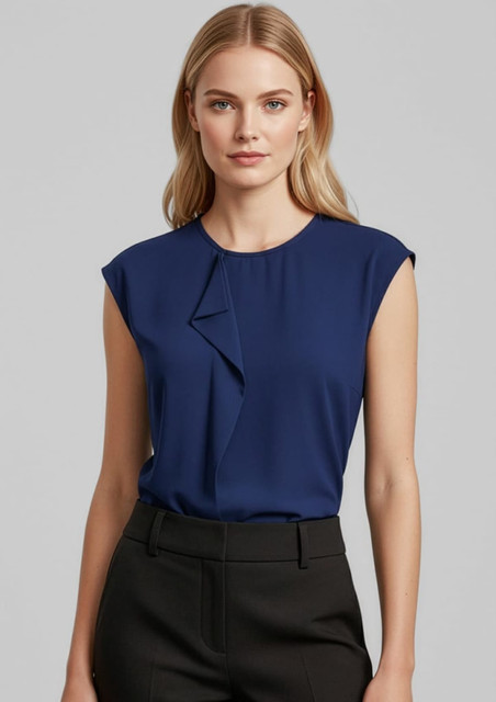 A women's navy top featuring a stylish ruffled design and cap sleeves, paired with black trousers.