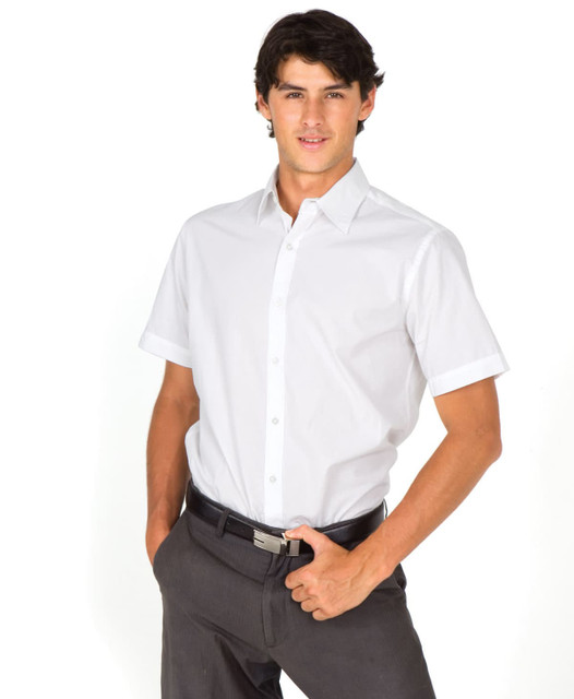 A short-sleeve button-up shirt in white, modelled by a man with dark hair, wearing grey trousers. The shirt features a logo.
