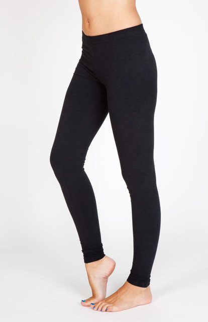 A pair of women's full-length leggings in black, made from cotton and spandex, displayed on a model.