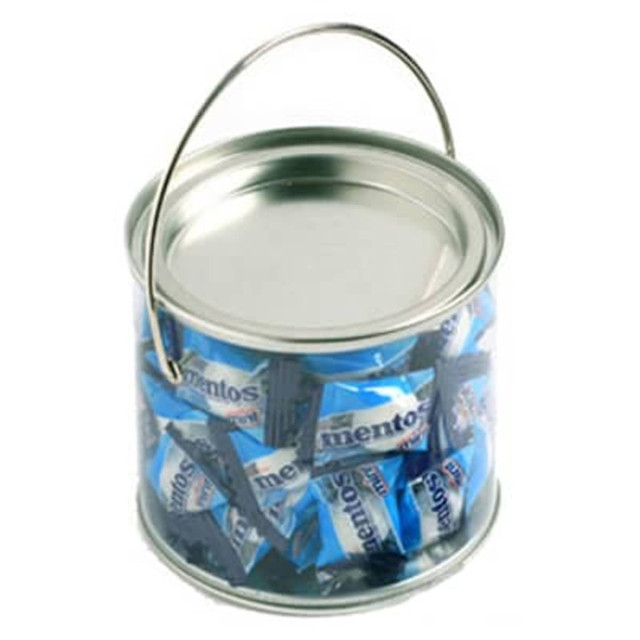 A silver bucket filled with blue-wrapped Mentos mints, featuring a handle for easy carrying.