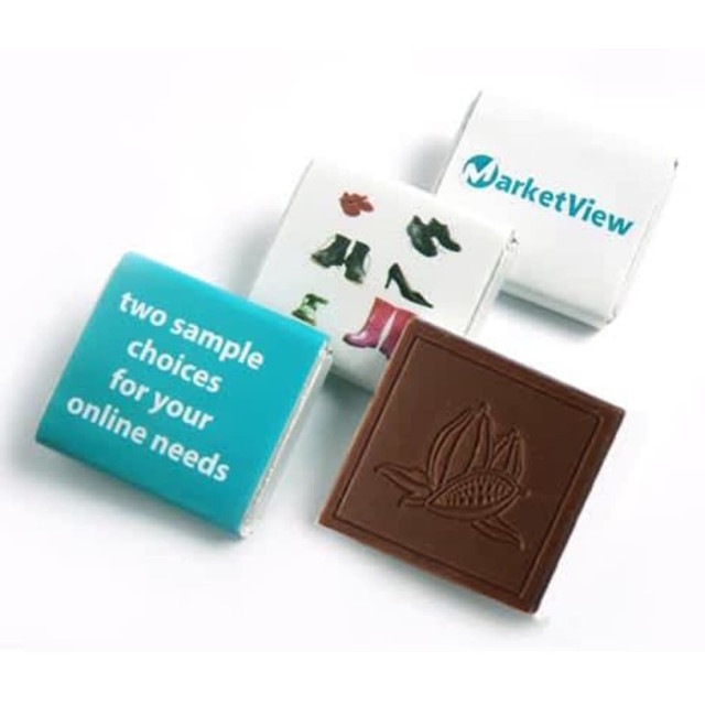A selection of chocolates, including two branded wrappers and one chocolate featuring a floral design, in brown and white packaging.