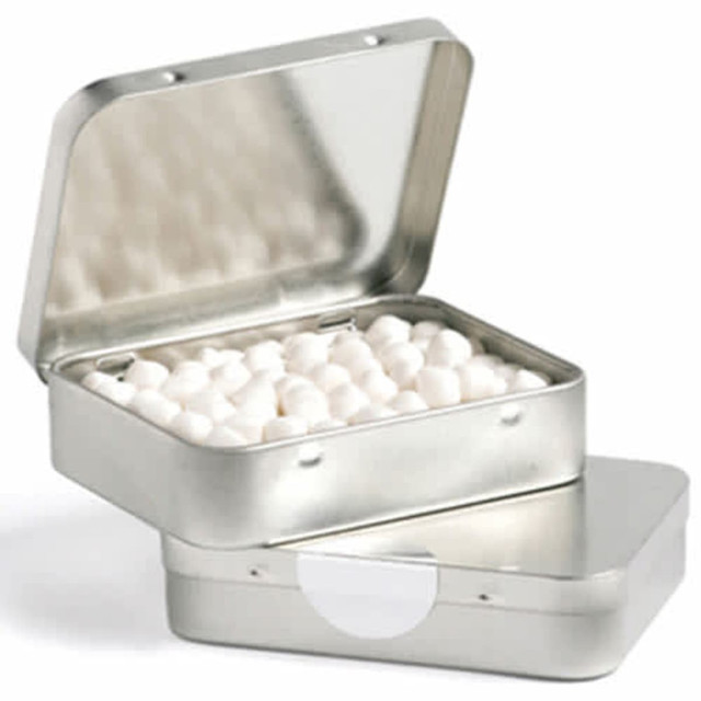 A rectangular silver tin with a hinged lid, filled with white mint balls inside.