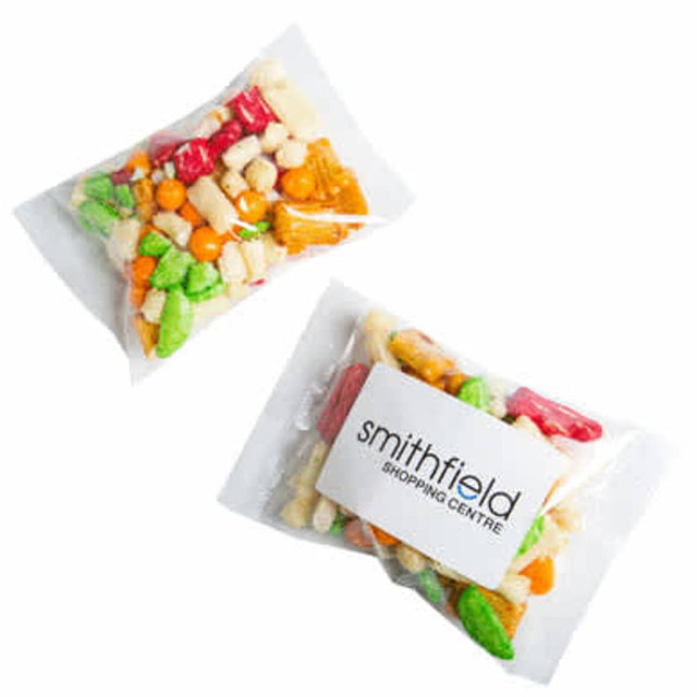 A clear plastic bag containing colourful rice crackers in various shapes and sizes, featuring a logo on the front.