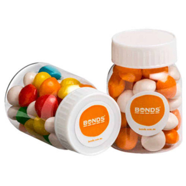 Two clear jars filled with colourful chewy fruit sweets, featuring orange, yellow, red, blue, and white pieces. Each jar has a lid and a logo.