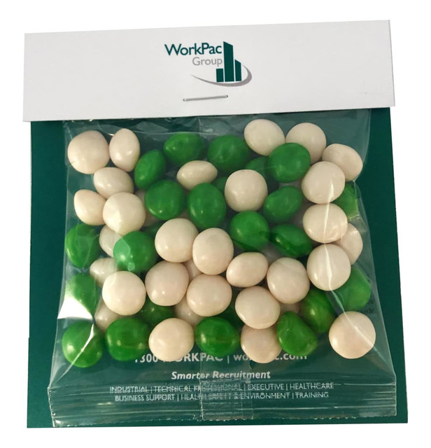 A sealed bag of chewy fruit balls in green and white, featuring a logo on the packaging.