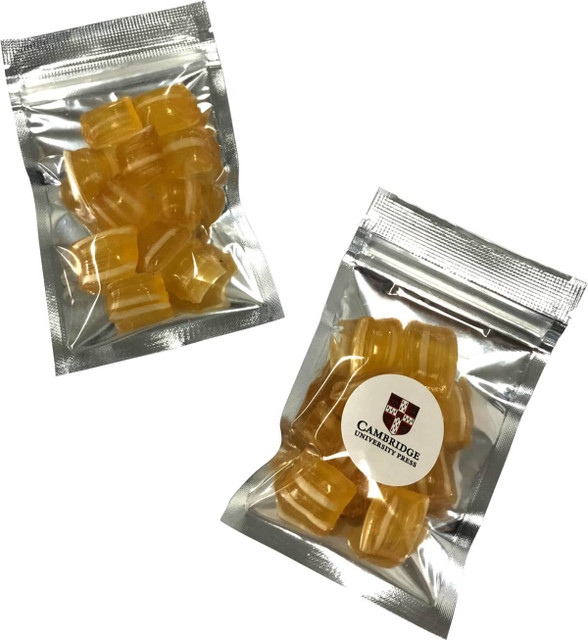 Silver zip lock bags containing eucalyptus lollies, featuring translucent yellow lozenges. Bags have branding on the front.