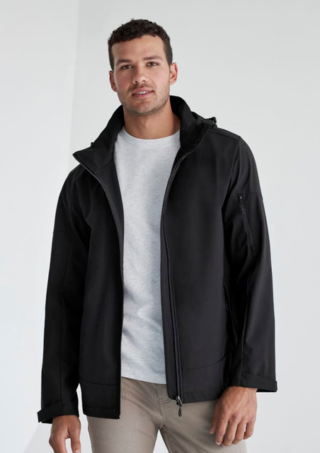 A man wearing a black rain jacket with a hood, featuring a zip-up front and a logo.