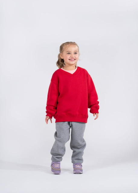 A blue kids v-neck fleece jumper with long sleeves and a ribbed hem. It features a brand label.