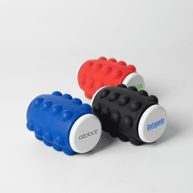 A set of three foam rollers in blue, red, and black, featuring various logos on the ends.