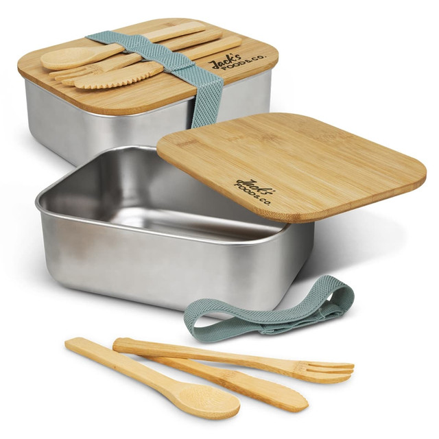 A stainless steel lunch box with a bamboo lid and cutlery, featuring a green strap. Contains wooden spoons and fork.