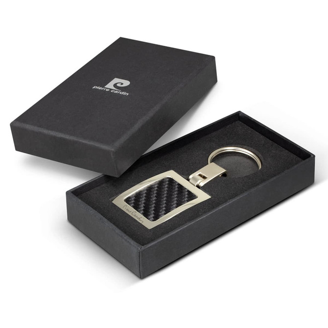 A key ring with a silver metal frame and a carbon fibre design, presented in a black box.