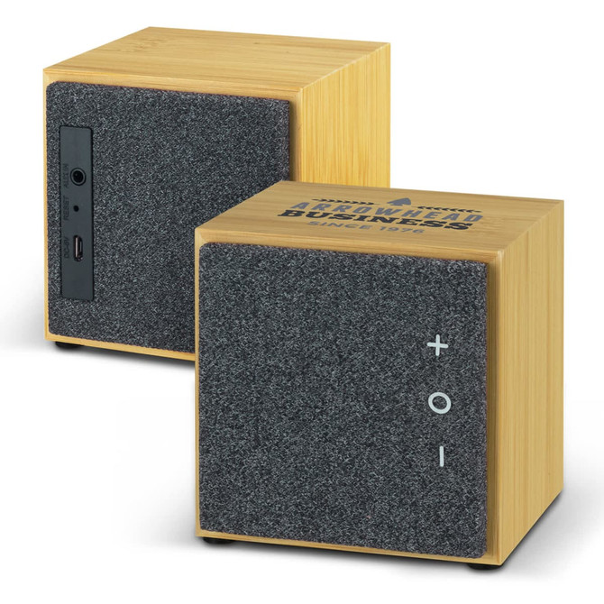 A square Bluetooth speaker featuring a bamboo finish and grey fabric front, with buttons and a logo on the side.
