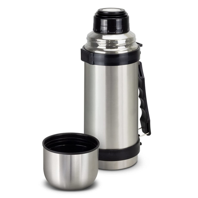 A stainless steel vacuum flask with a black handle and a matching cup, featuring a logo on the side.