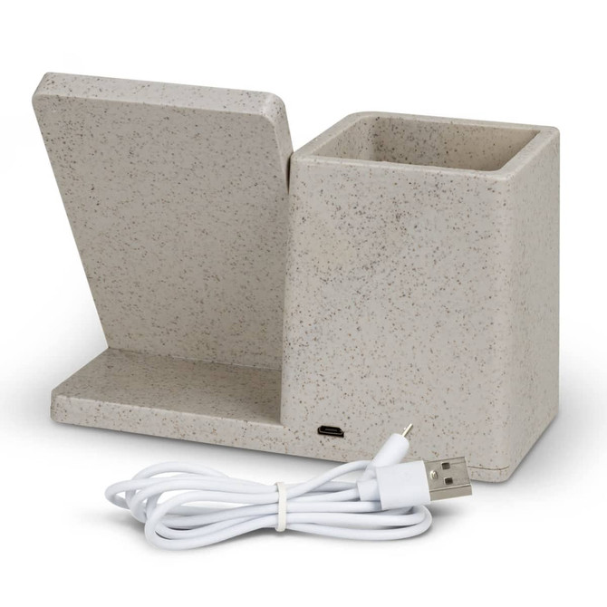 A beige wireless charger desk caddy with a slot for devices and a compartment for storage, accompanied by a USB charging cable.