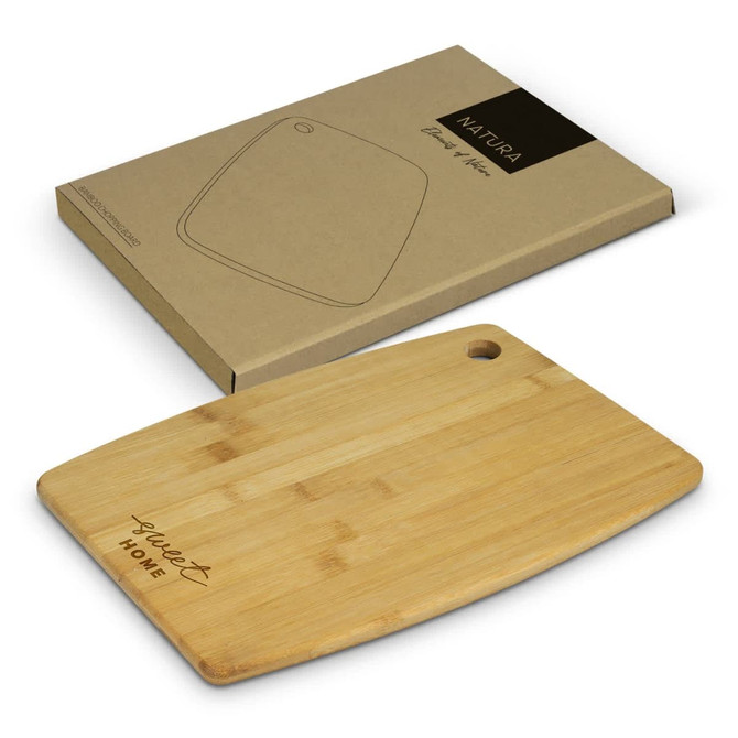A bamboo chopping board in a natural finish, displayed on a kraft paper boxed packaging, with a logo.