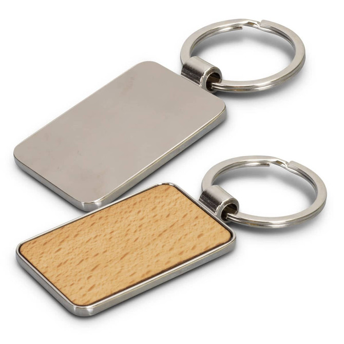 A rectangular key ring featuring a polished metal surface and a wooden back, attached to a metal keychain.