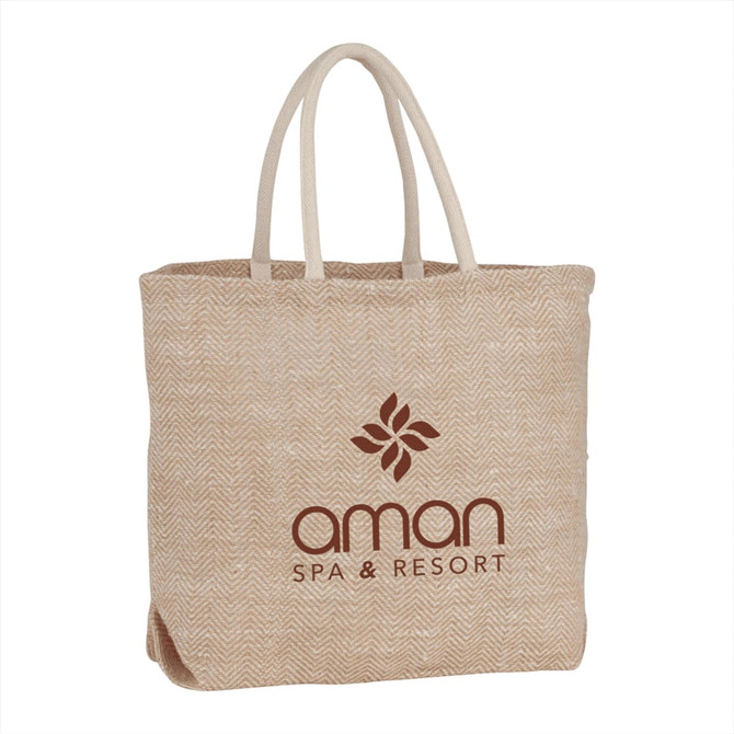 A herringbone jute tote bag in beige with two handles and a logo on the front.