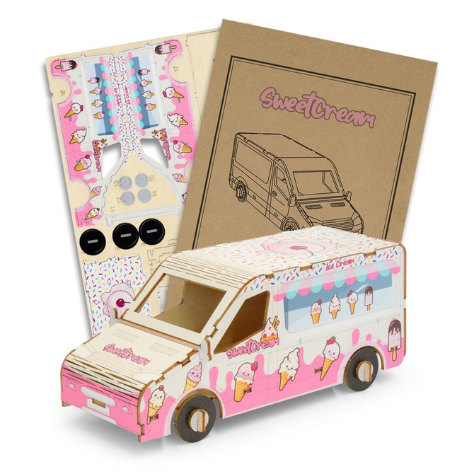 A pink and white wooden ice cream van model kit with assembly instructions and parts.
