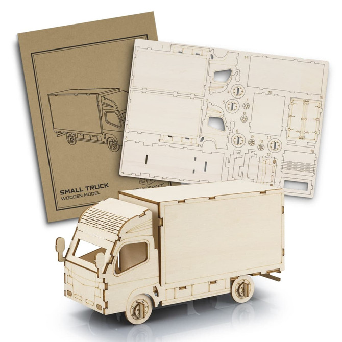 A wooden model of a small truck in natural wood colour, accompanied by a design sheet for assembly.