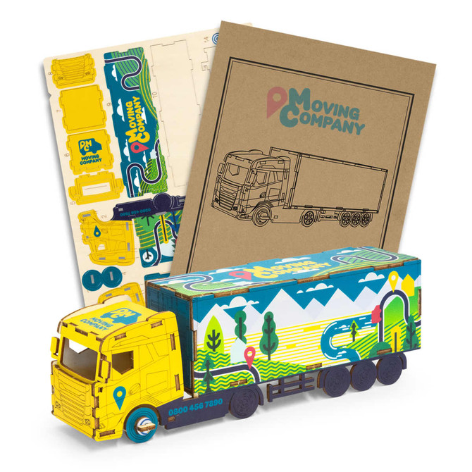 A wooden model of a large truck in yellow and blue, accompanied by craft sheets and assembly instructions.